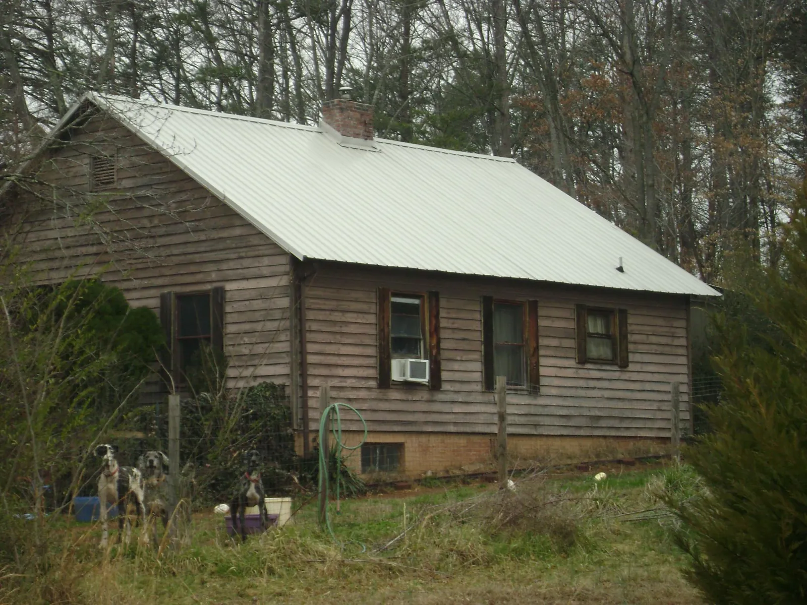 White metal roof on an old wood sided farmhouse, from a Metal Roof Installation job in North Grafton